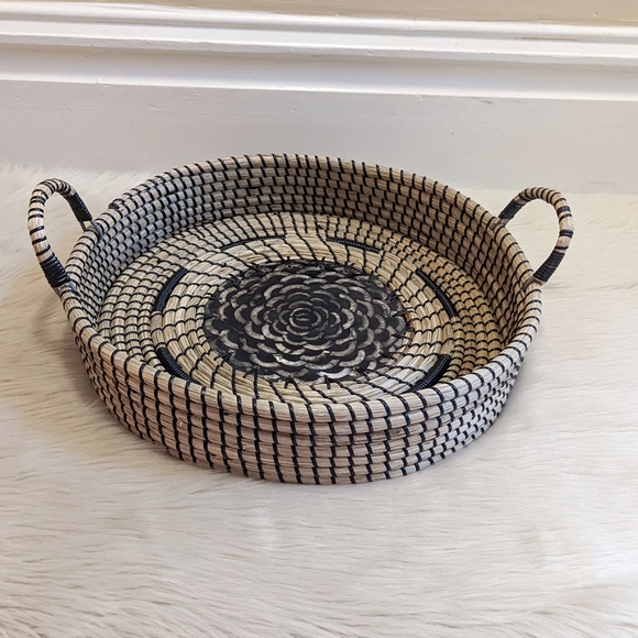 Other - Decorative round light wicker and black handles basket with flower in middle.